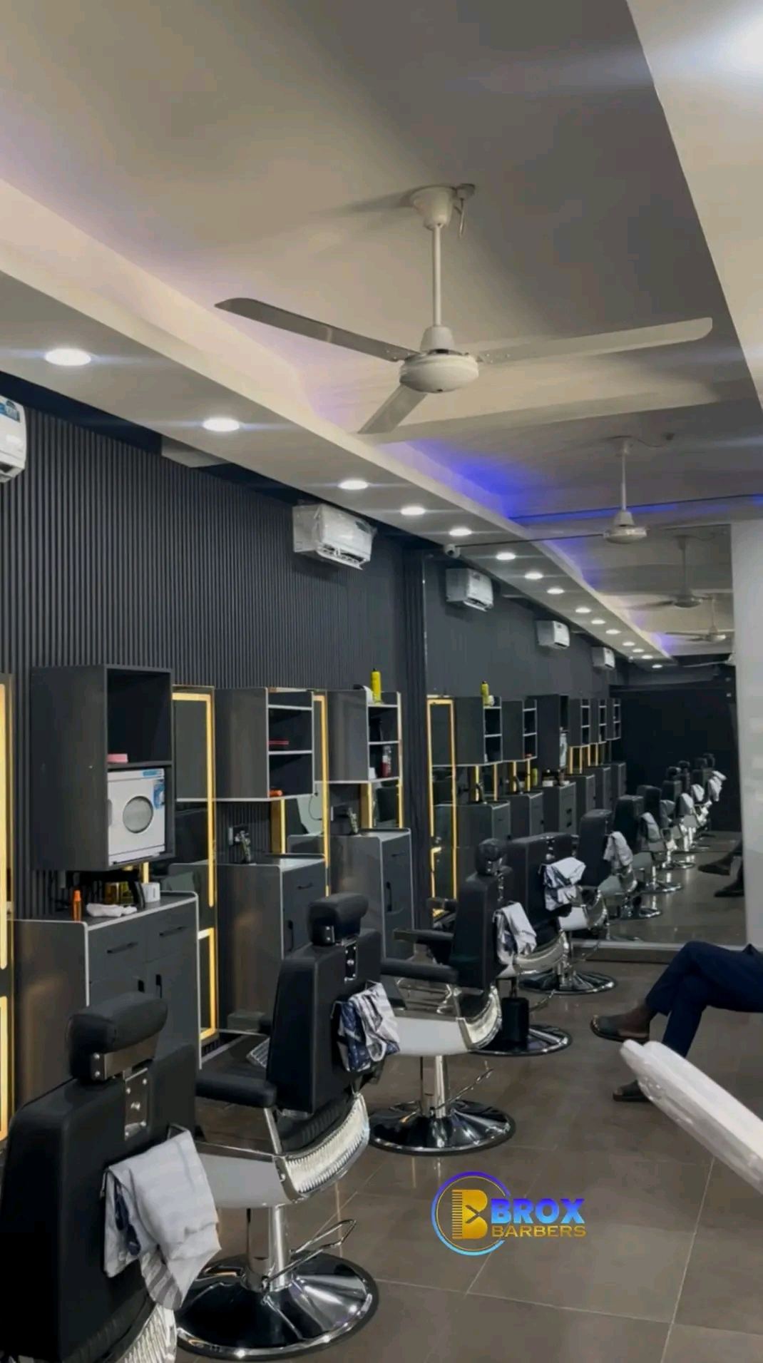 Row of styling stations at BROX BARBERS